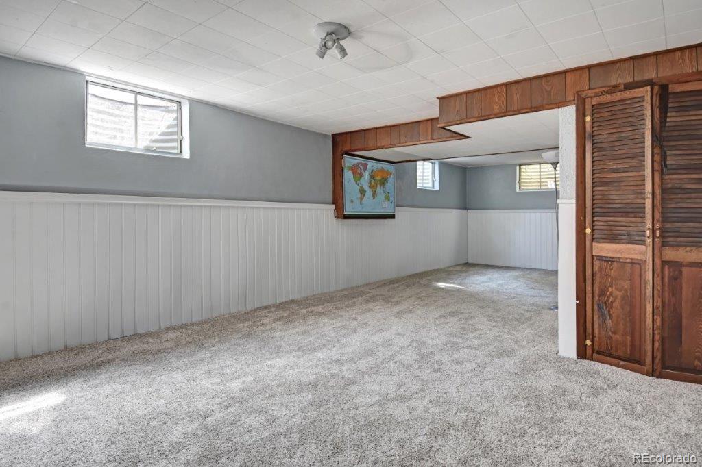 7856 Baseline Road Boulder, CO 80303 - Photo 28 of 40 a view of an empty room with window and stairs