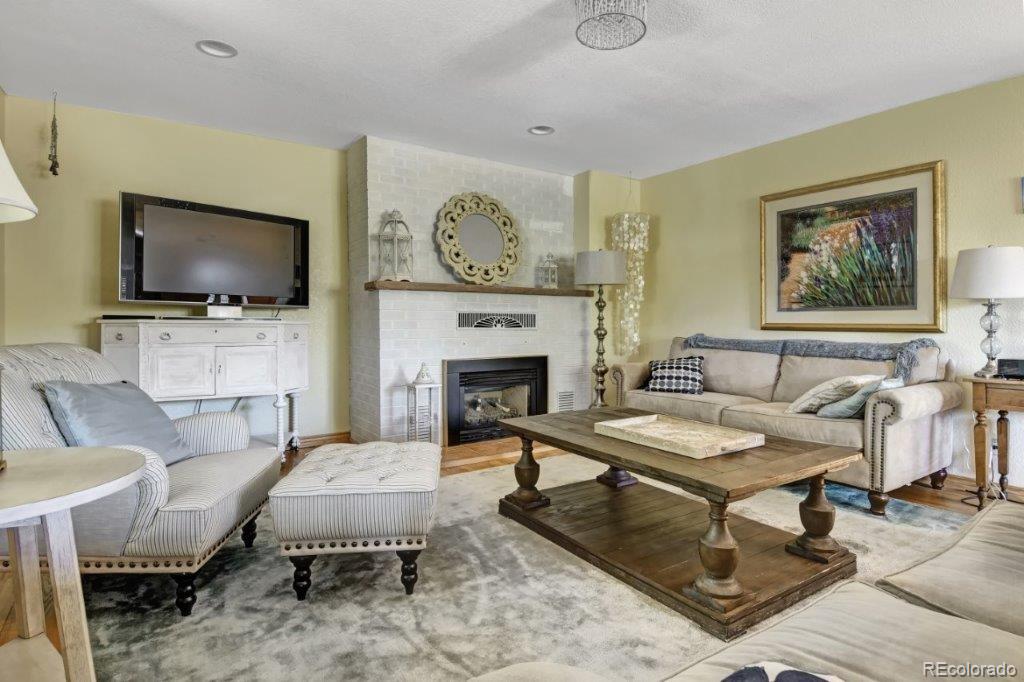 7856 Baseline Road Boulder, CO 80303 - Photo 6 of 40 a living room with furniture a flat screen tv and a fireplace