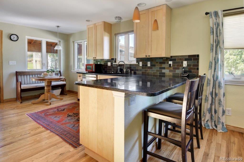 7856 Baseline Road Boulder, CO 80303 - Photo 8 of 40 a kitchen with a table chairs stove and granite counter top