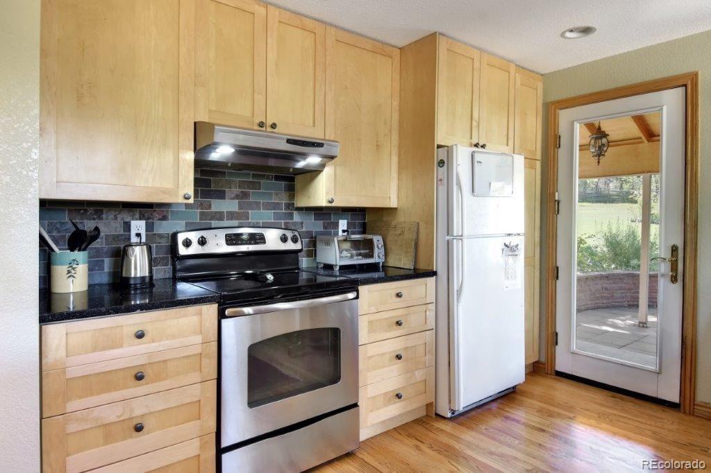 7856 Baseline Road Boulder, CO 80303 - Photo 9 of 40 a kitchen with granite countertop a stove and a refrigerator