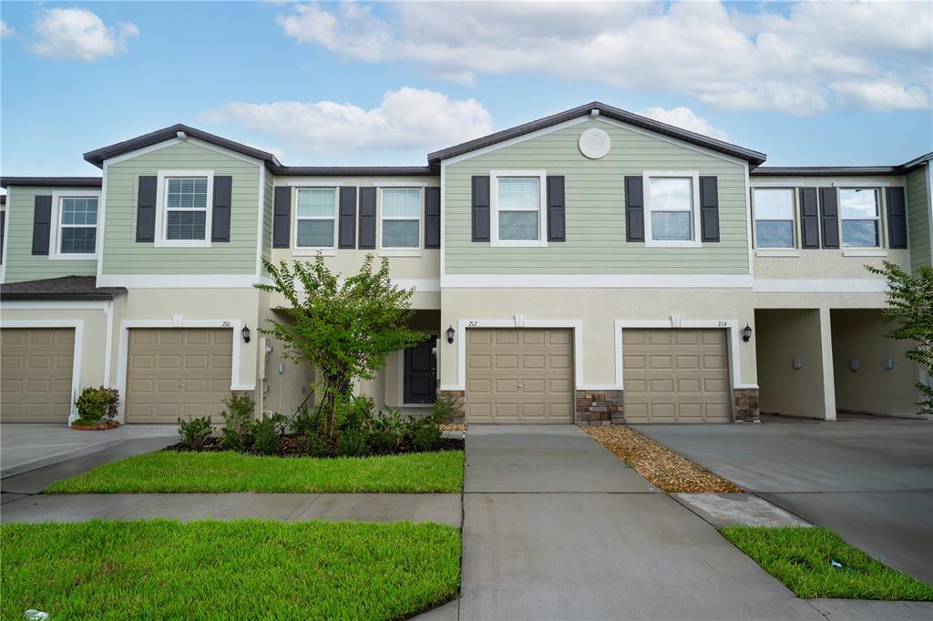 212 27th Street Southeast Ruskin, FL 33570 - Photo 1 of 46 a front view of a house with a yard and garage