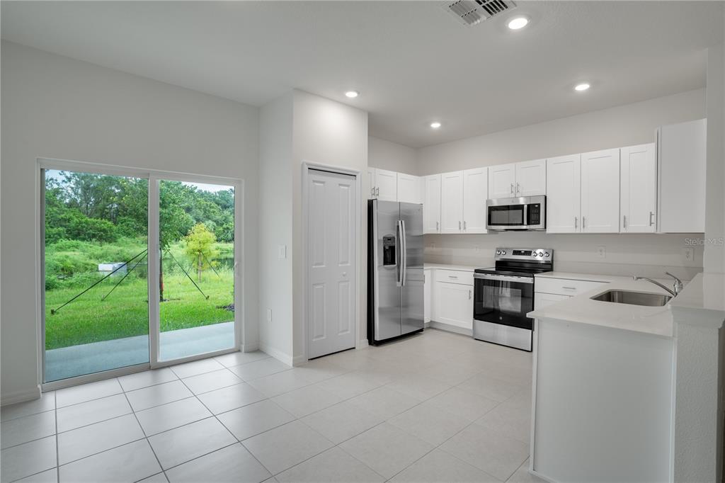 212 27th Street Southeast Ruskin, FL 33570 - Photo 12 of 46 a kitchen with stainless steel appliances a refrigerator sink and stove