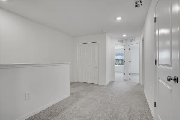 a view of an empty walk in closet with empty racks