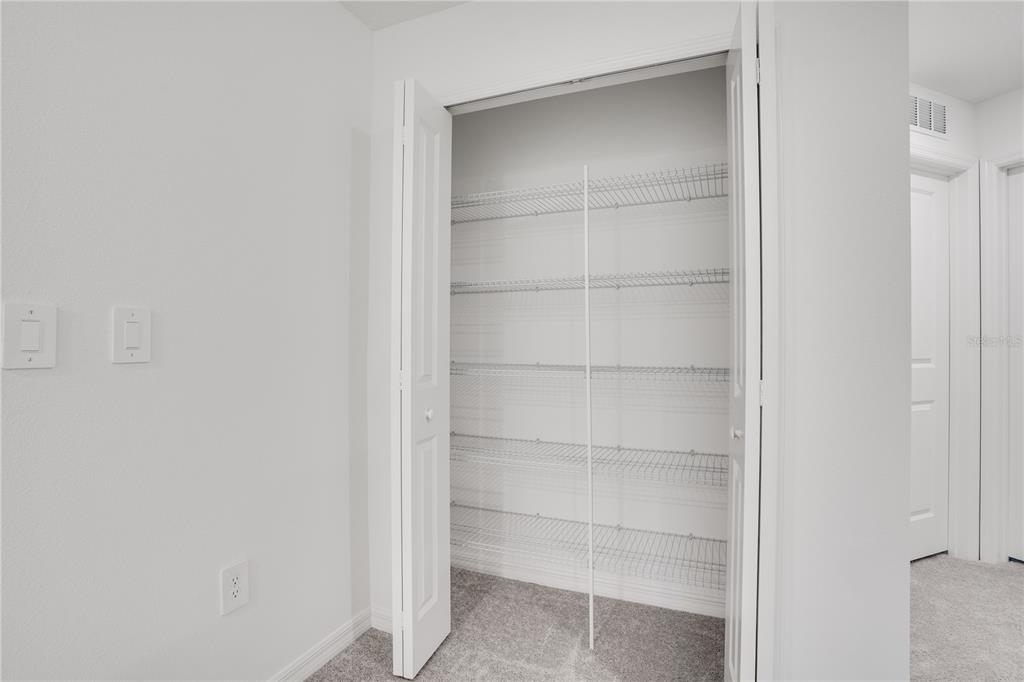 212 27th Street Southeast Ruskin, FL 33570 - Photo 18 of 46 a view of an empty walk in closet with empty racks