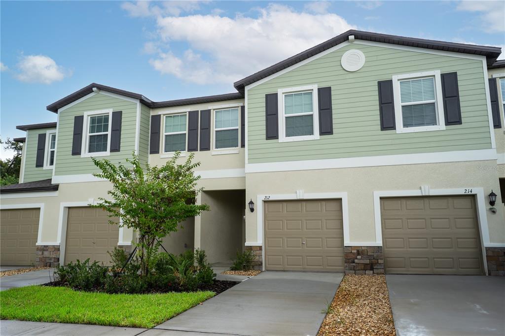 212 27th Street Southeast Ruskin, FL 33570 - Photo 2 of 46 a front view of a house with a yard