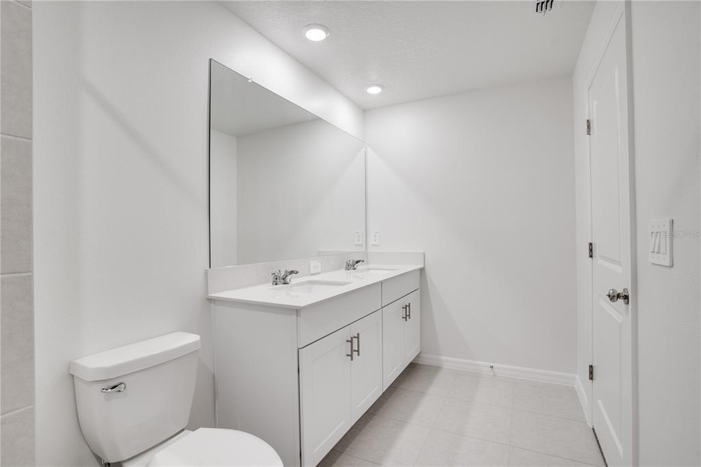 212 27th Street Southeast Ruskin, FL 33570 - Photo 25 of 46 a spacious bathroom with a toilet sink and mirror