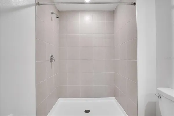 a bedroom with a large bed and a potted plant