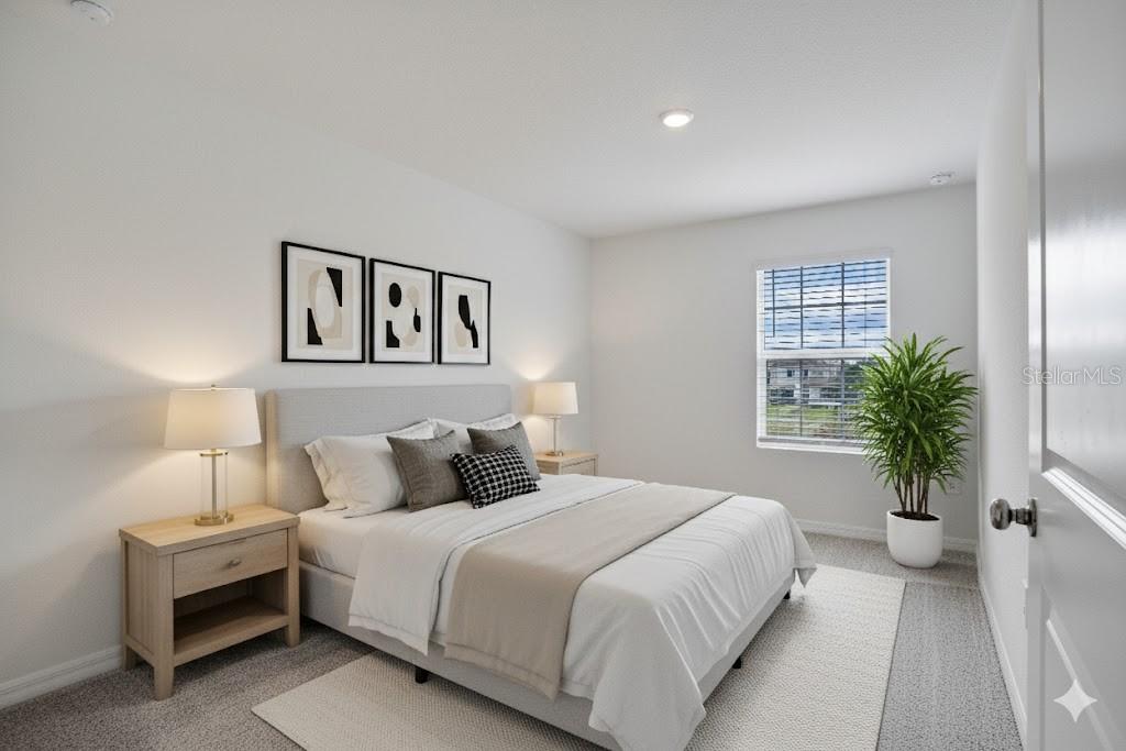 212 27th Street Southeast Ruskin, FL 33570 - Photo 27 of 46 a bedroom with a large bed and a potted plant