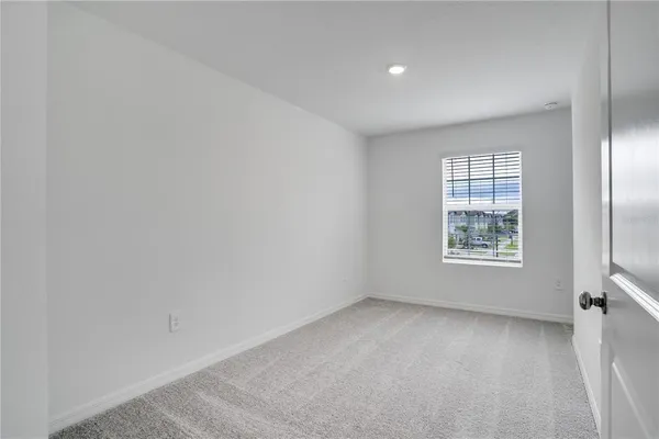 a bedroom with a bed and a potted plant