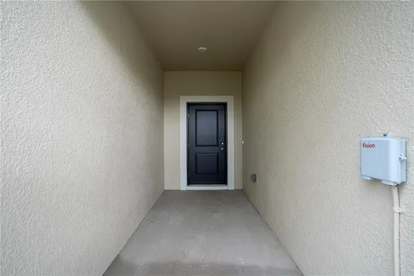 a view of a hallway with wooden floor and table