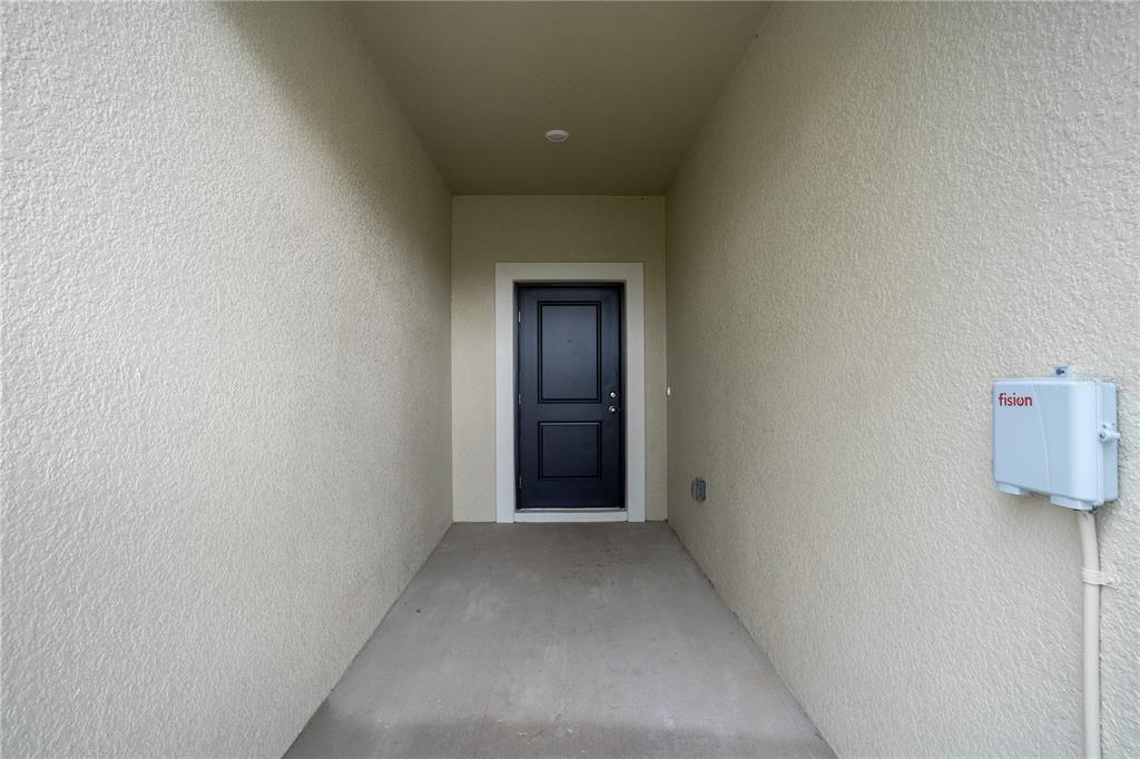 212 27th Street Southeast Ruskin, FL 33570 - Photo 3 of 46 a view of a hallway with wooden floor and table