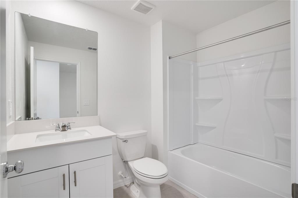 212 27th Street Southeast Ruskin, FL 33570 - Photo 31 of 46 a bathroom with a sink a toilet and a mirror