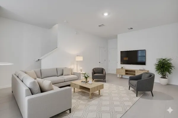 a living room with furniture and a flat screen tv