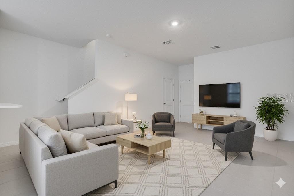 212 27th Street Southeast Ruskin, FL 33570 - Photo 7 of 46 a living room with furniture and a flat screen tv