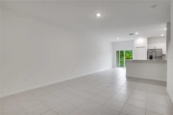 a kitchen with stainless steel appliances a stove a refrigerator a sink and a fireplace