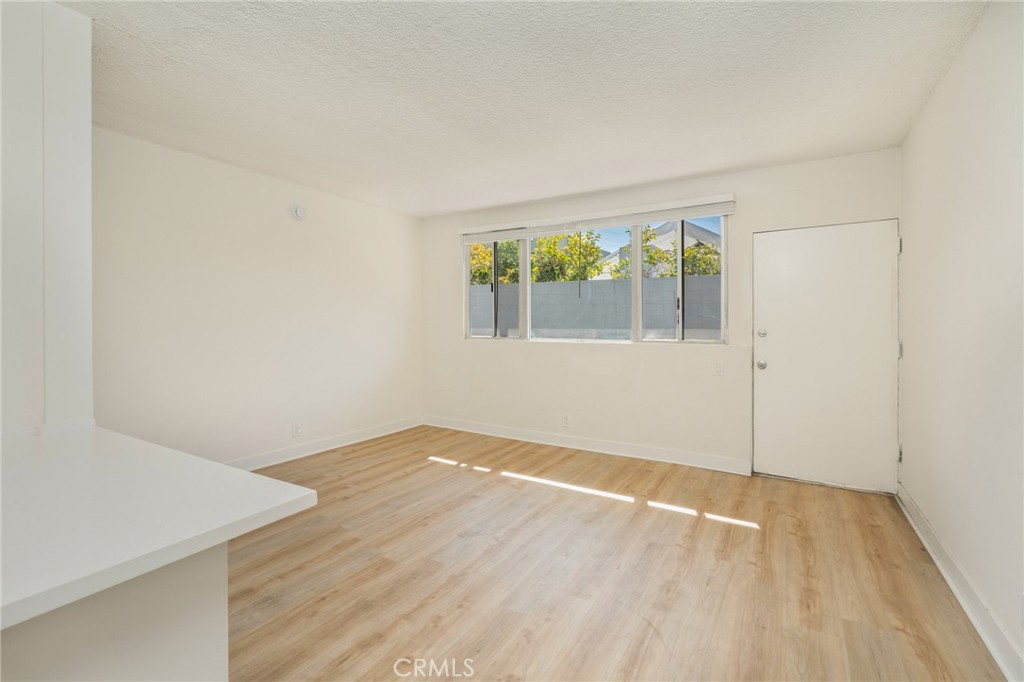 1626 Pine Avenue Long Beach, CA 90813 - Photo 11 of 23 an empty room with wooden floor and windows