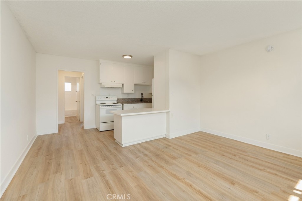 1626 Pine Avenue Long Beach, CA 90813 - Photo 12 of 23 a kitchen with a white cabinets and wooden floor