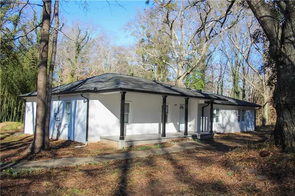 a view of a house with a yard and garage