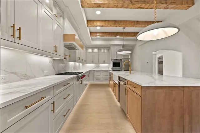 a kitchen with cabinets and wooden floor