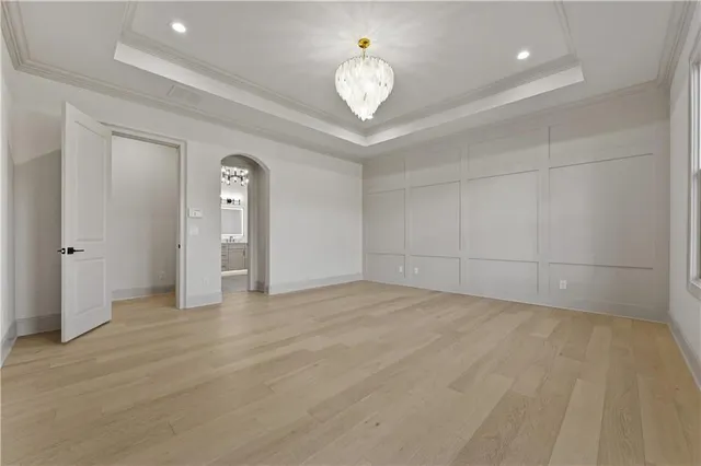 a spacious bathroom with a double vanity sink a mirror a bathtub and shower