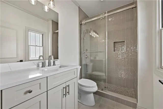 an empty room with windows and ceiling fan