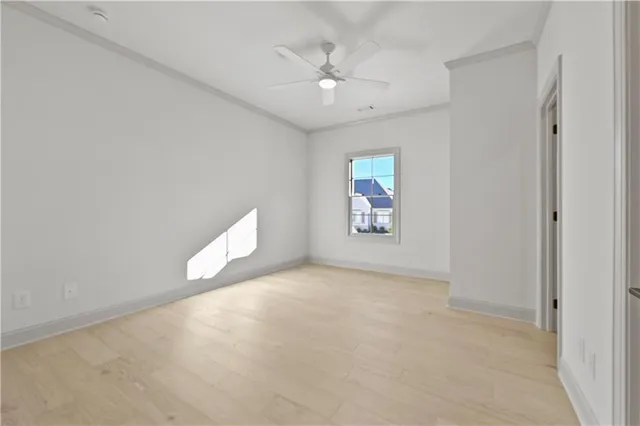 an empty room with a ceiling fan and a window