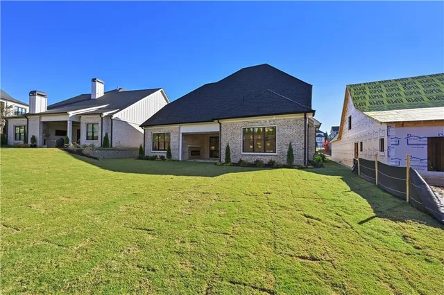 a big room with wooden floor and a fireplace