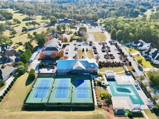 an aerial view of residential houses with yard