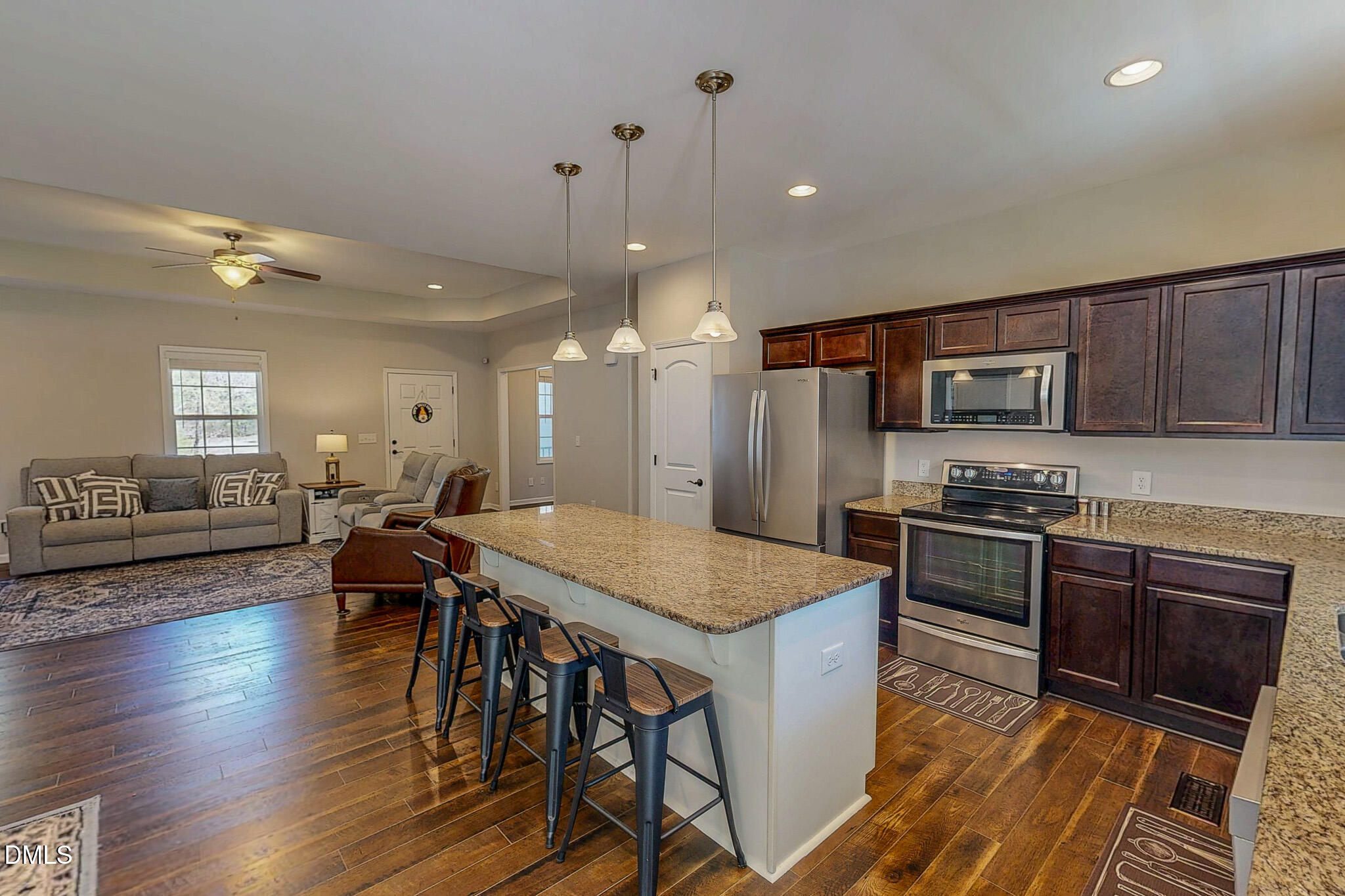 2223 Holeman Ashley Road Timberlake, NC 27583 - Photo 12 of 42 a kitchen with stainless steel appliances granite countertop wooden floors stove top oven and refrigerator