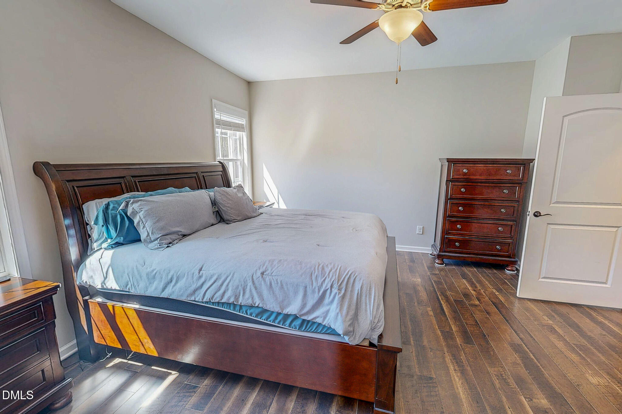 2223 Holeman Ashley Road Timberlake, NC 27583 - Photo 16 of 42 a bed sitting in a bedroom and wooden floor