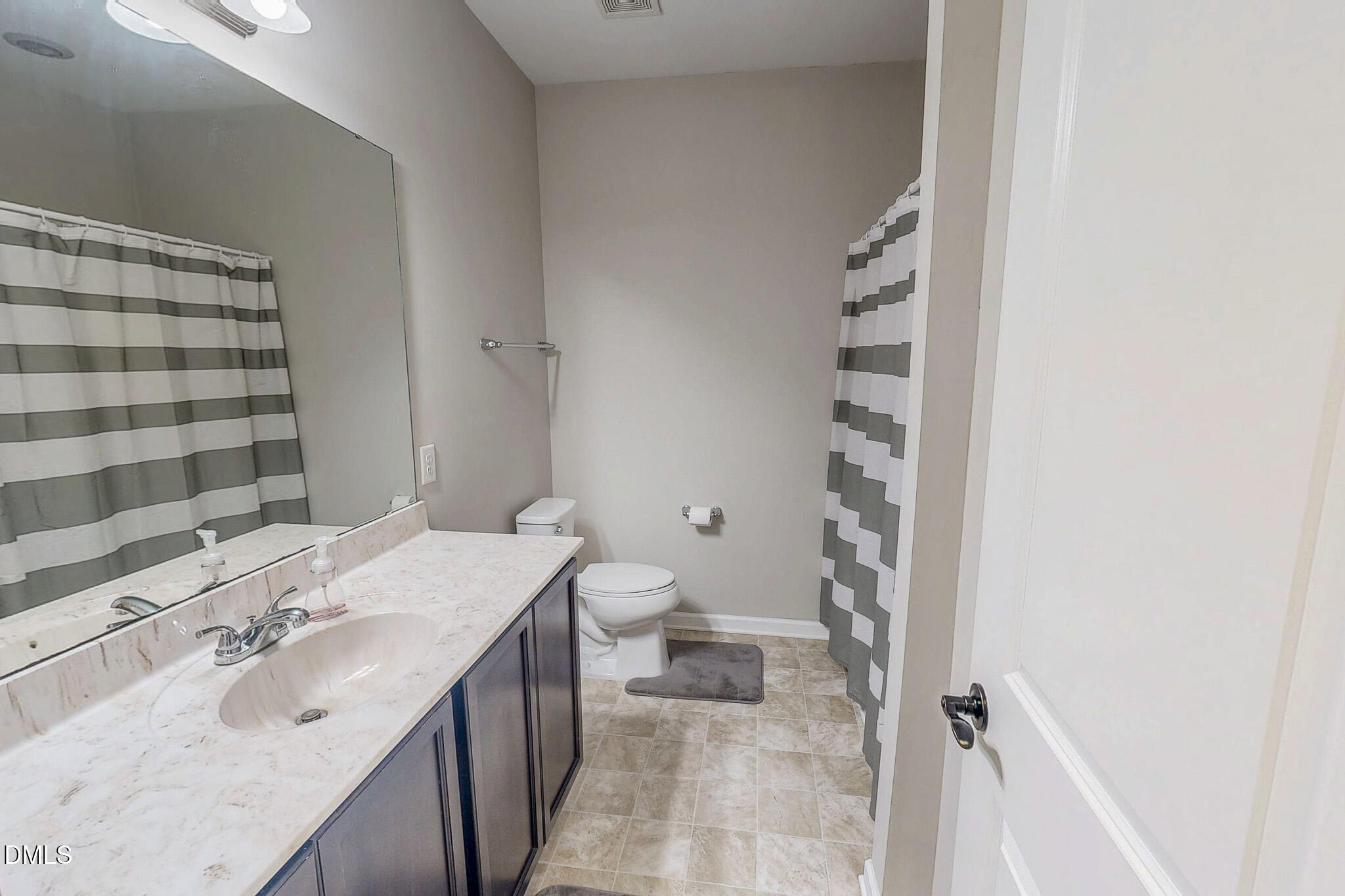 2223 Holeman Ashley Road Timberlake, NC 27583 - Photo 36 of 42 a bathroom with a granite countertop sink toilet and shower
