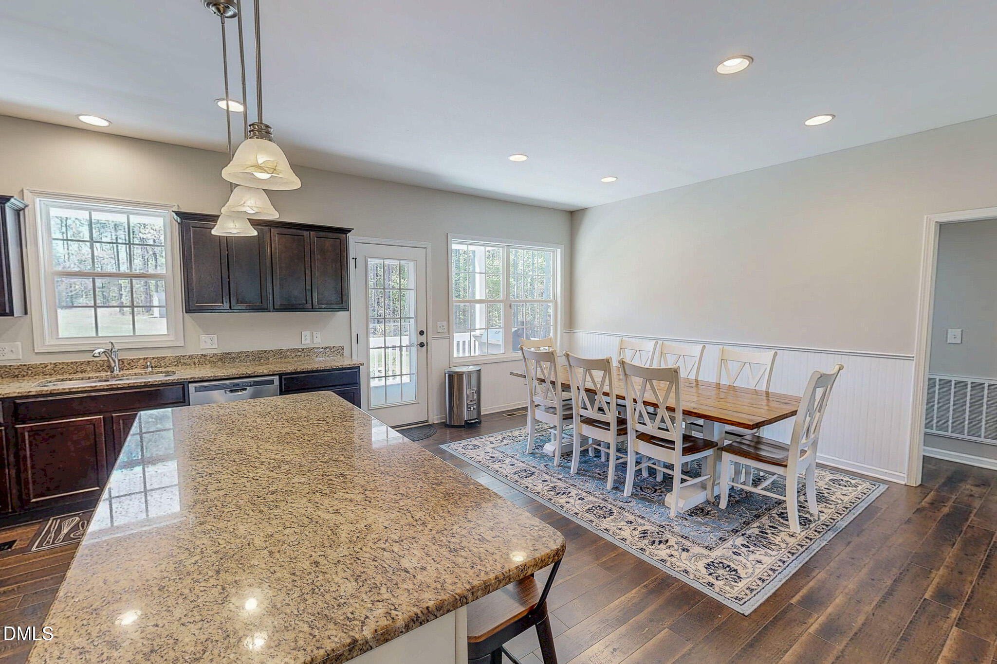 2223 Holeman Ashley Road Timberlake, NC 27583 - Photo 40 of 42 a living room with dining table wooden floor and a chandelier
