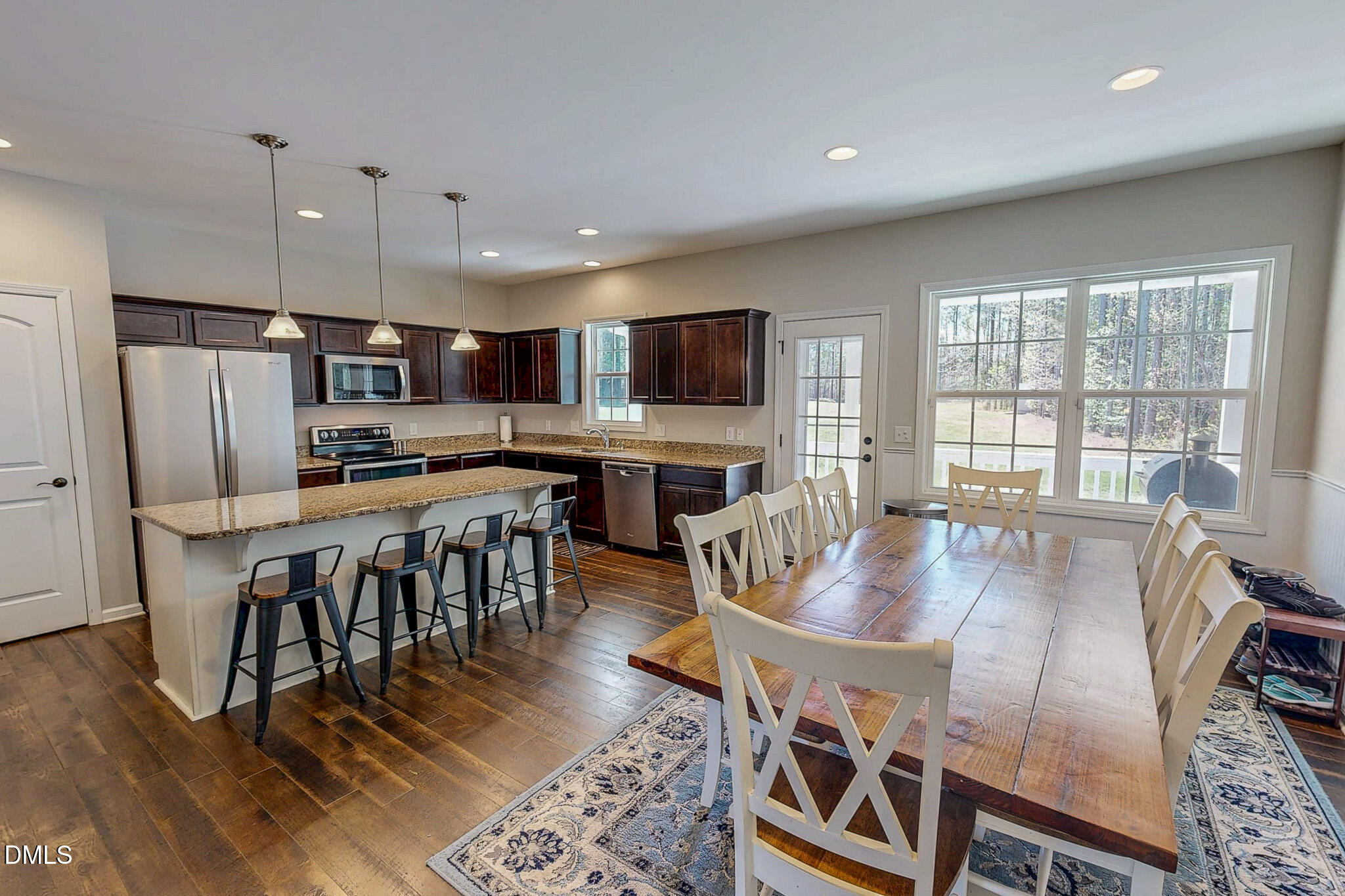 2223 Holeman Ashley Road Timberlake, NC 27583 - Photo 4 of 42 a living room with stainless steel appliances furniture a dining table and kitchen view