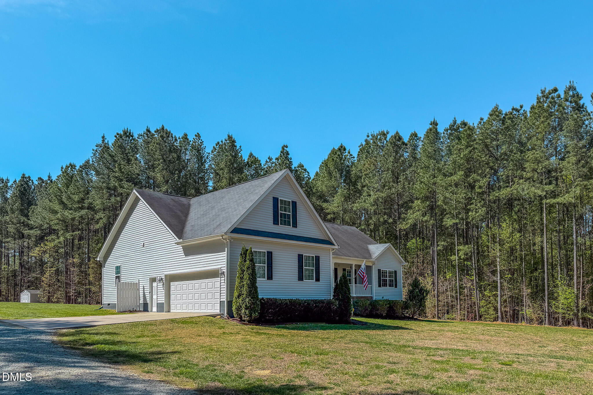 2223 Holeman Ashley Road Timberlake, NC 27583 - Photo 42 of 42 a front view of a house with a garden and trees