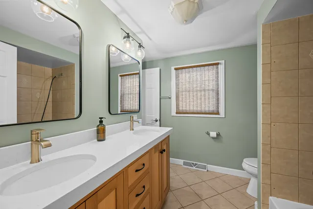 a bathroom with a sink a toilet and mirror