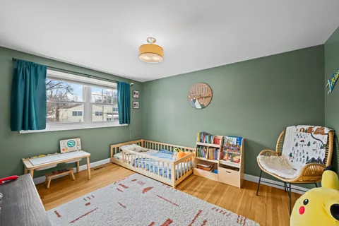 a bedroom with furniture and a wooden floor