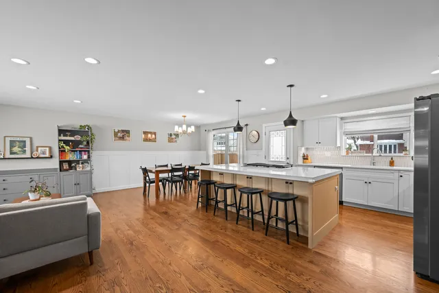 a large kitchen with a large counter top furniture a center island and stainless steel appliances