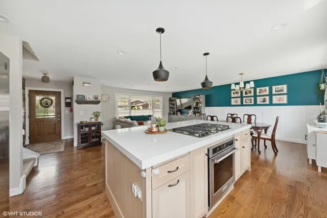 a kitchen with a stove and chairs