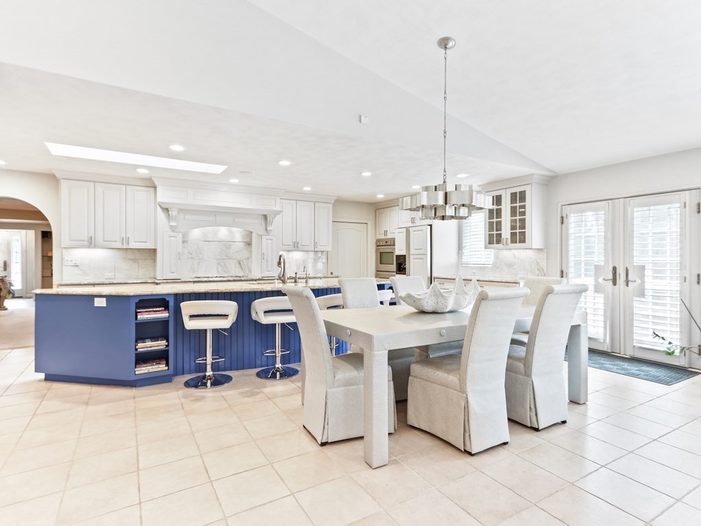 325 Manning Street Needham, MA 02492 - Photo 11 of 31 a large kitchen with a table chairs refrigerator and cabinets