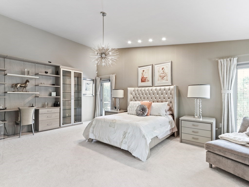325 Manning Street Needham, MA 02492 - Photo 17 of 31 a spacious bedroom with a large bed and a chandelier