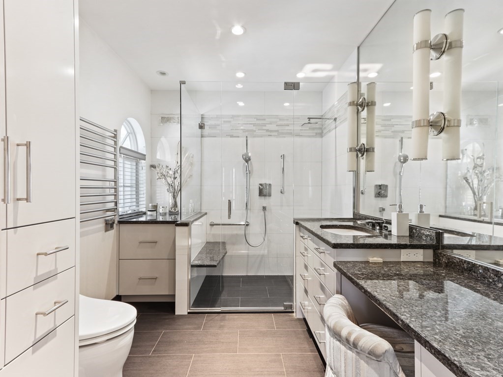 325 Manning Street Needham, MA 02492 - Photo 19 of 31 a large bathroom with a granite countertop sink a toilet a mirror and shower