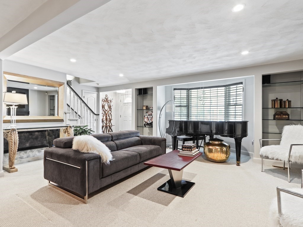 325 Manning Street Needham, MA 02492 - Photo 5 of 31 a living room with furniture a window and gym equipment