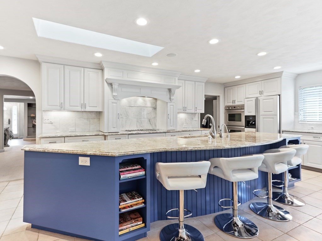 325 Manning Street Needham, MA 02492 - Photo 9 of 31 a kitchen with granite countertop a counter space dining table and stainless steel appliances