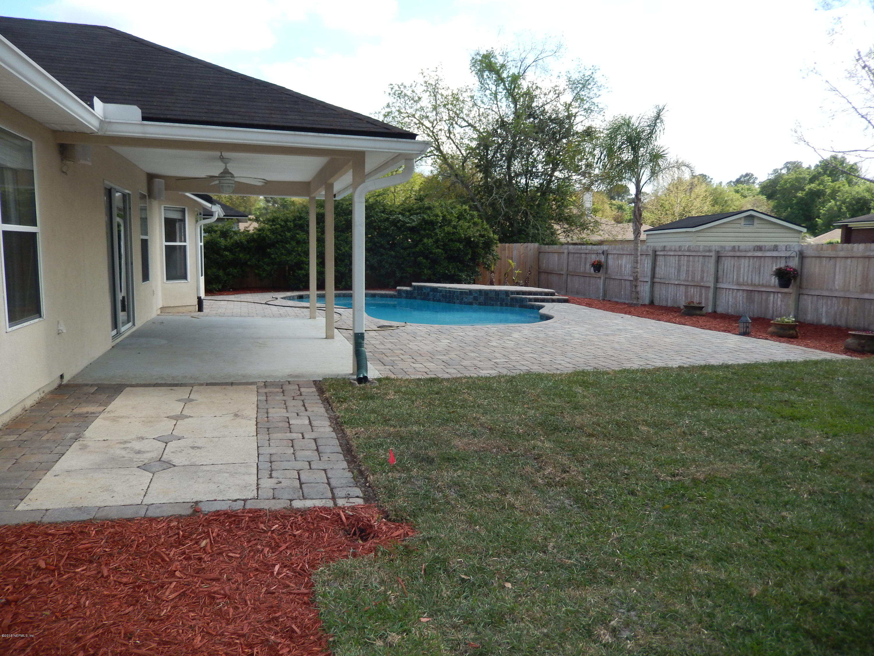 2468 Mallory Hills Road Jacksonville, FL 32221 - Photo 4 of 27 a view of a patio with table and chairs with wooden fence