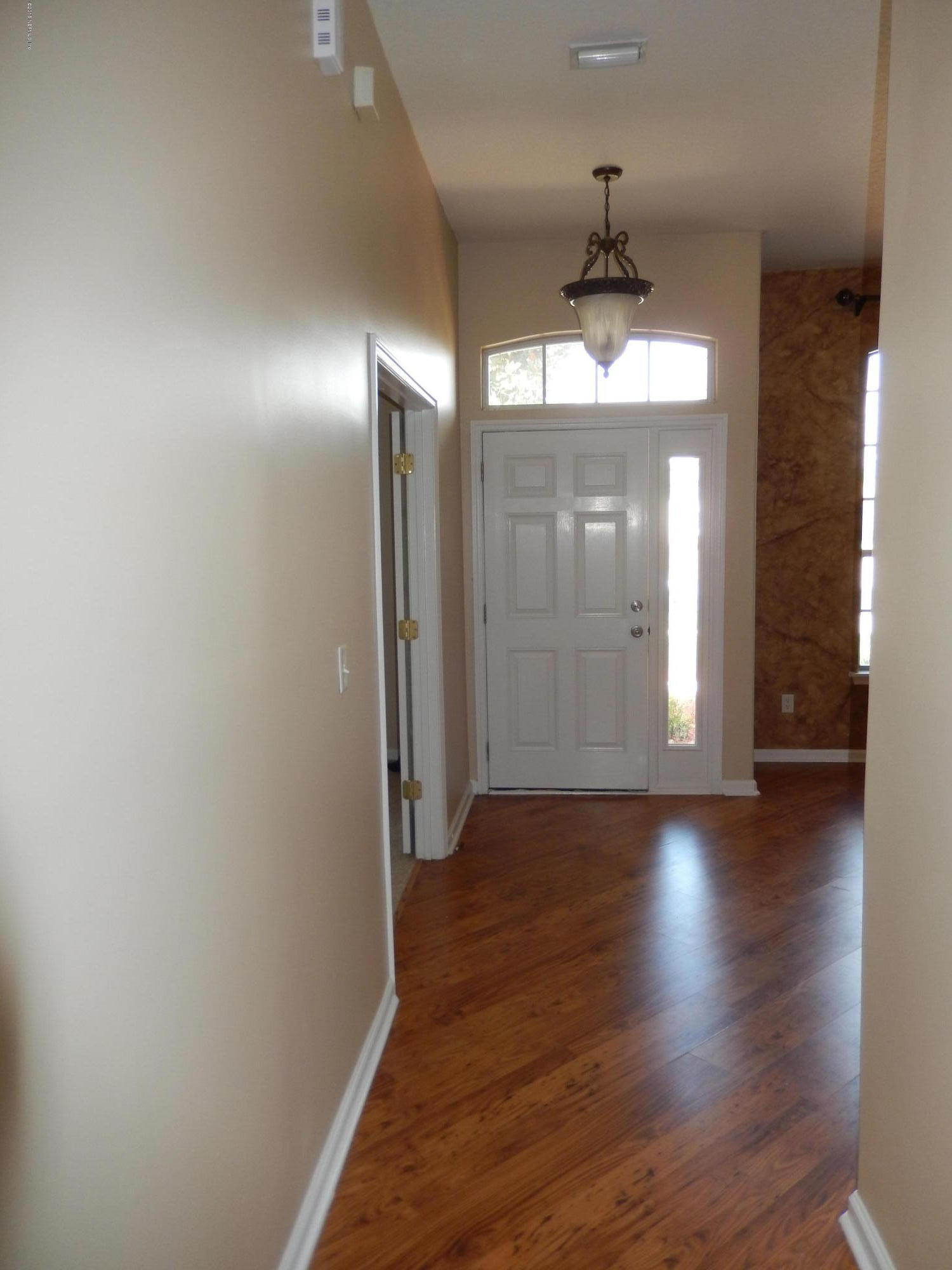 2468 Mallory Hills Road Jacksonville, FL 32221 - Photo 5 of 27 a view of a hallway with wooden floor