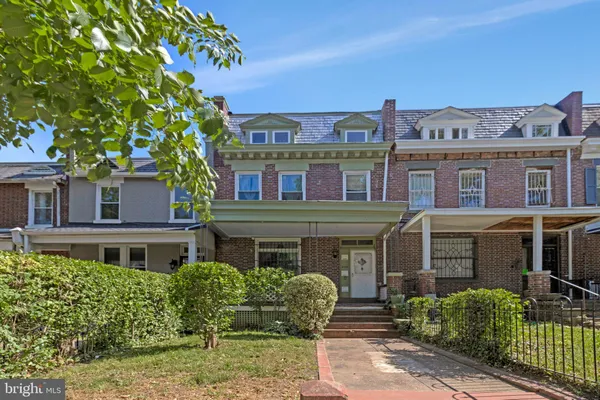 a front view of a residential apartment building with a yard
