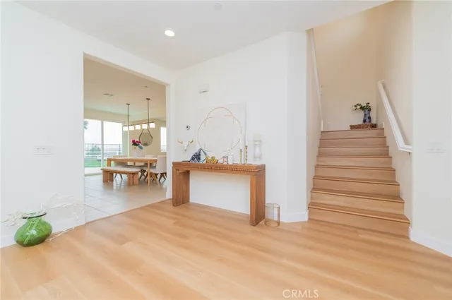 a view of a living room and kitchen with furniture and wooden floor