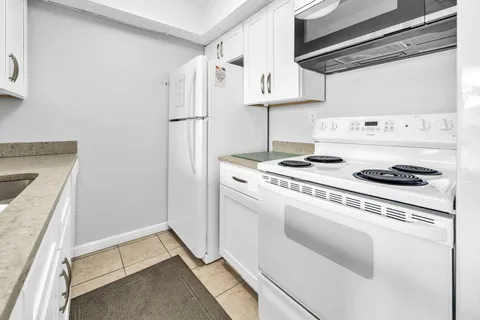 a kitchen with a sink and a refrigerator