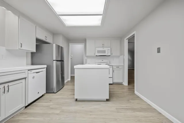 a utility room with cabinets washer and dryer