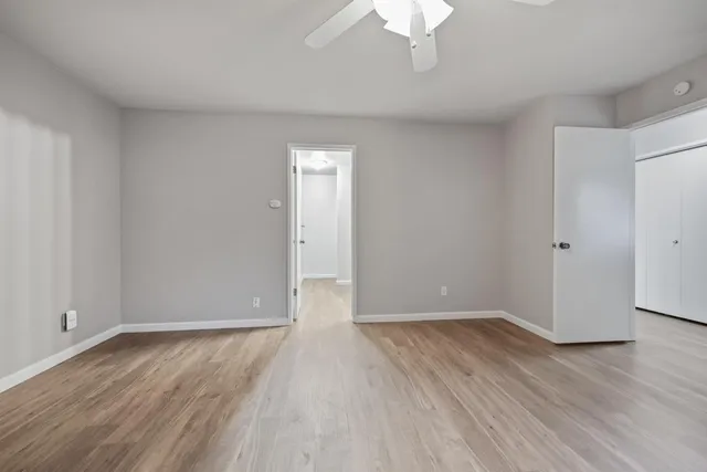 a view of an empty room with wooden floor